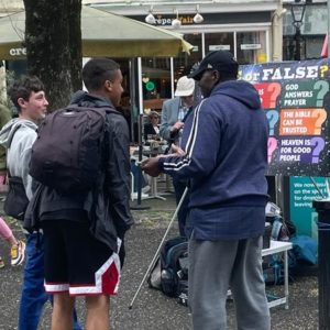 Patrick speaking to some men at the Brighton Fringe Festival 2023