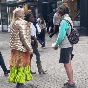 Christine speaking with a tarot card reader at the Brighton Fringe Festival 2023