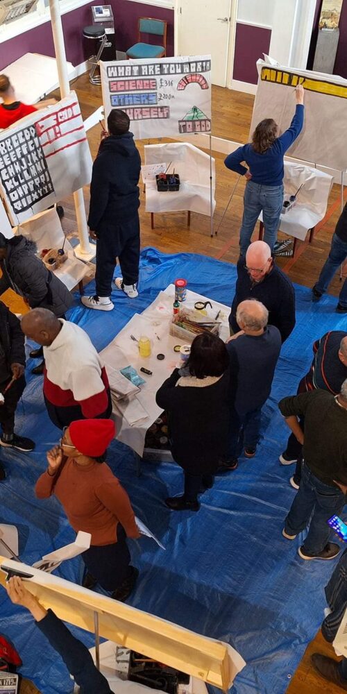 a number of people practising sketchboard painting