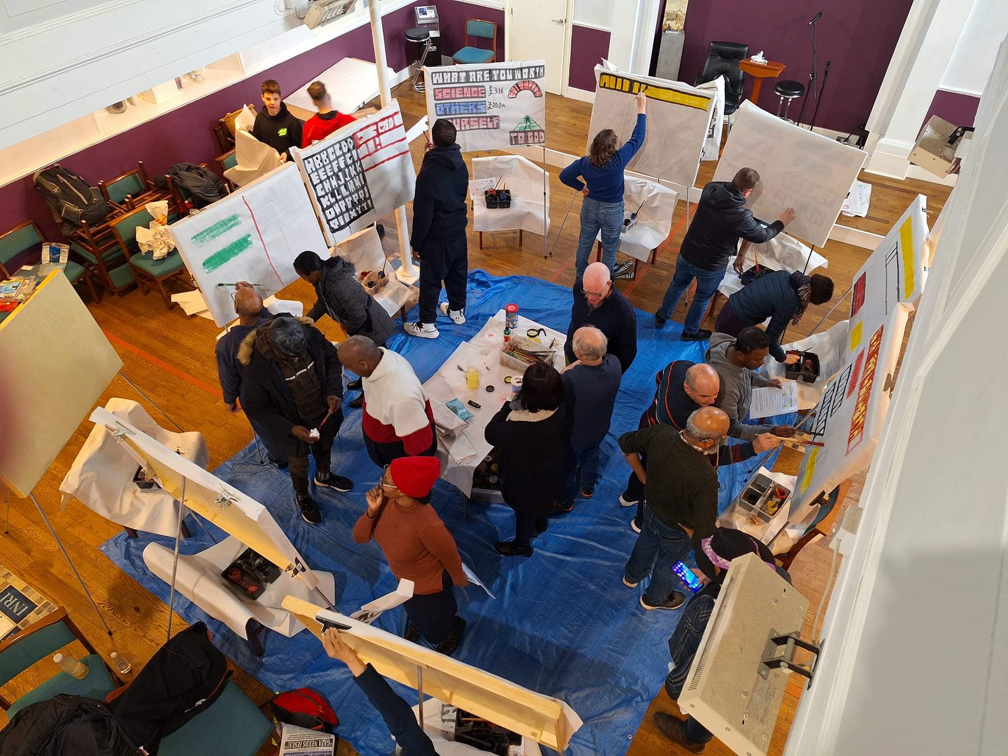 a number of people practising sketchboard painting