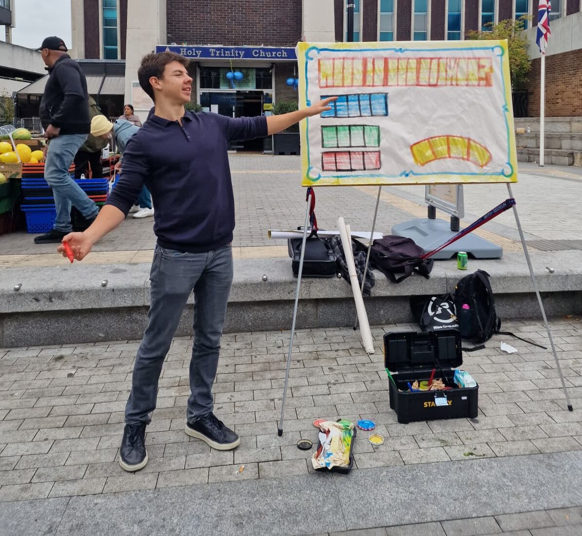 Edward preaching a sketchboard message outside a church